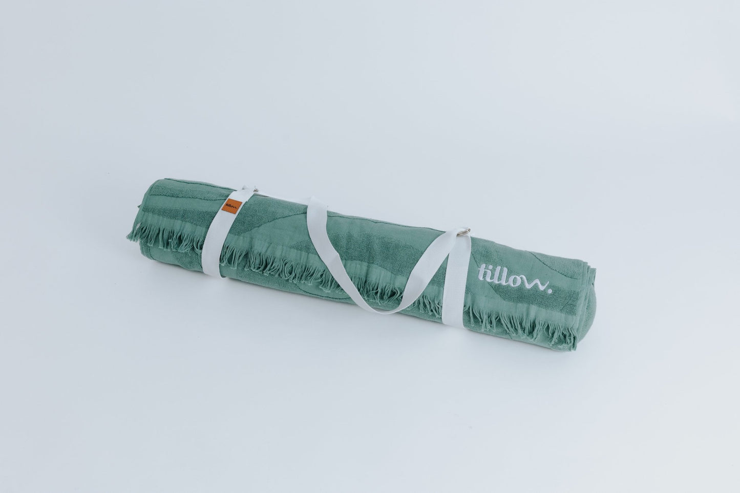 green beach towel with white carry straps